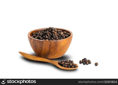 Pile of black pepper seeds with black pepper seeds in wooden spoon and in wooden cup on white background with clipping path.