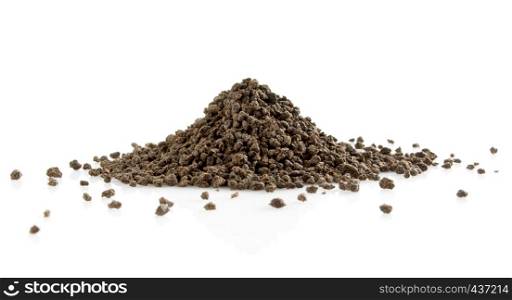 Pile of black tea granulates isolated on white background