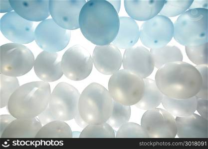 pile of blue and white balloons isolated on white background
