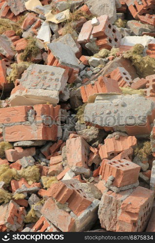 Pile of broken red bricks on construction site