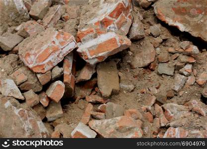 Pile of broken red bricks on construction site