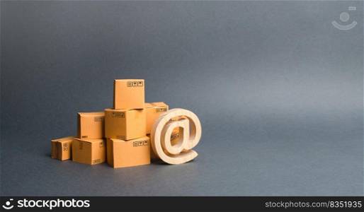 Pile of cardboard boxes and symbol commercial AT. shopping online. E-commerce. sales of goods and services through online trading platforms. development of Internet network trade, advertising services