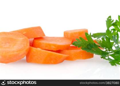 Pile of carrot slices closeup on white reflective background.