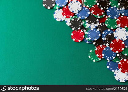 Pile of Casino pocker gambling chips on green table.. Pile of Casino pocker gambling chips on green table