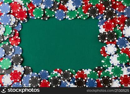 Pile of Casino pocker gambling chips on green table.. Pile of Casino pocker gambling chips on green table
