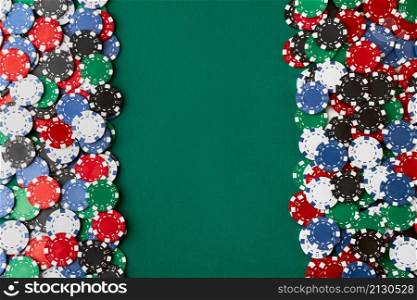 Pile of Casino pocker gambling chips on green table.. Pile of Casino pocker gambling chips on green table