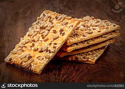 Pile of cereal cookies with seeds on a wooden table