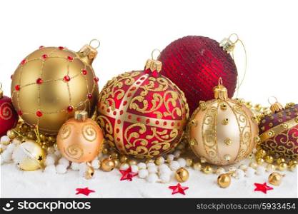 Pile of Christmas balls . Heap of christmas balls in gold and red colors in snow border isolated on white background