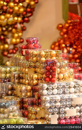 Pile of Christmas baubles in plastic boxes in decoration store