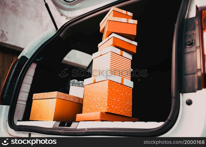 pile of Christmas gift boxes in car