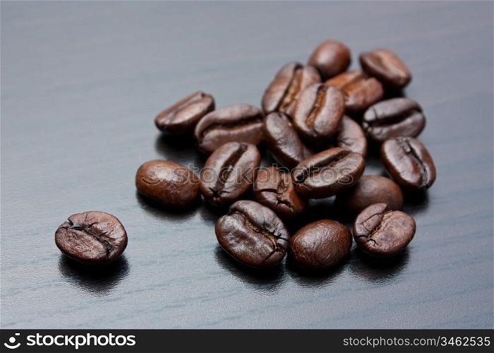 pile of coffee beans on a gray table