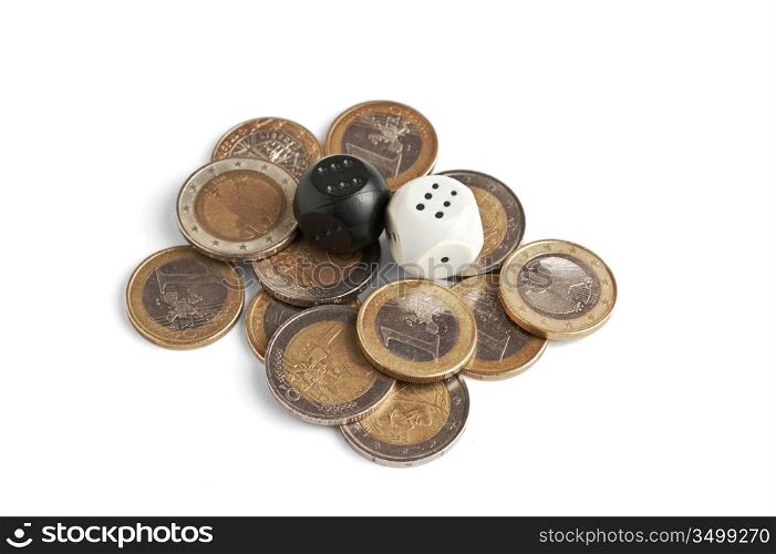 pile of coins and dice isolated on a white background