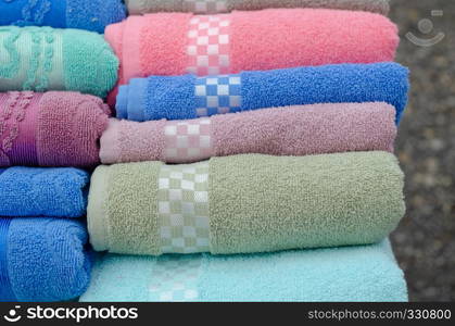 Pile of colored towels for sale at the market