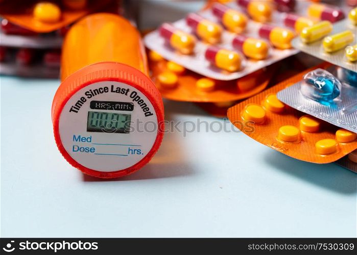 Pile of colorful medical pills in blisters and bottles border on blue background. Drug and antibiotics prescription for treatment medication.. Pile of pills