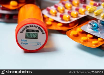 Pile of colorful medical pills in blisters and bottles border on blue background. Drug and antibiotics prescription for treatment medication.. Pile of pills