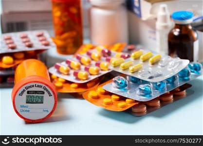 Pile of colorful medical pills in blisters and bottles on blue background. Drug and antibiotics prescription for treatment medication.. Pile of pills