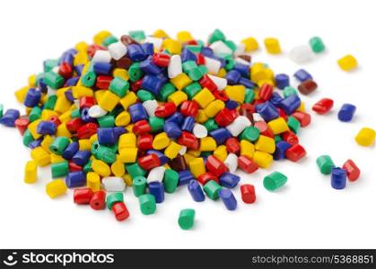 Pile of colorful plastic polymer granules isolated on white