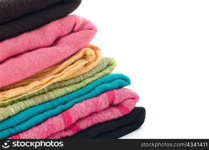 Pile of colorful scarves over white background.