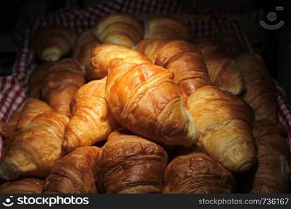 pile of croissant bread on buffet line