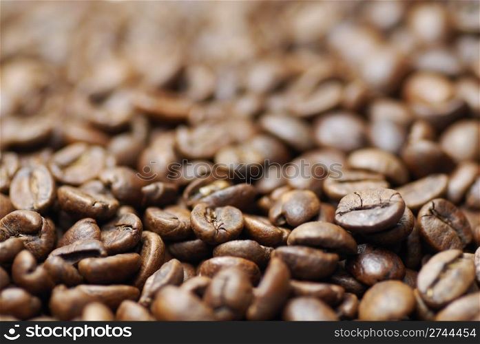Pile of decaffinated coffee beans, short DOF focus on foreground.