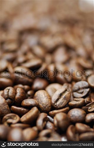 Pile of decaffinated coffee beans, short DOF focus on foreground.