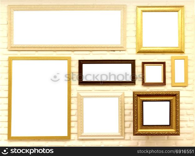 pile of empty picture frames on brick wall