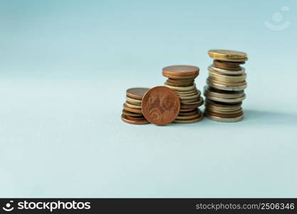 Pile of euro coins on a blue background, close-up. Place for an inscription. Pile of euro coins on a blue background, close-up. Place for an inscription.