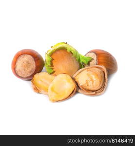 Pile of filbert nuts with green leaf isolated on white background