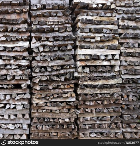 pile of firewood forms an almost abstract wooden pattern