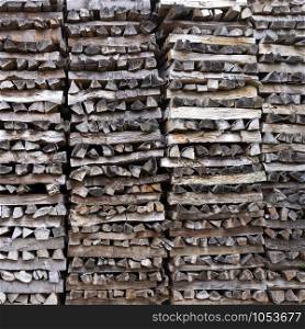 pile of firewood forms an almost abstract wooden pattern