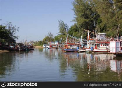 pile of fishing boat in canal with beautiful sky background