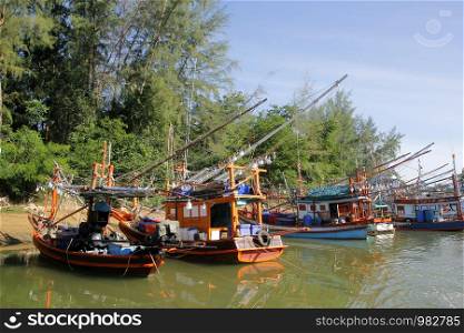 pile of fishing boat in canal with beautiful sky background