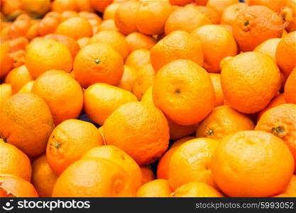 Pile of fresh orange mandarins at market