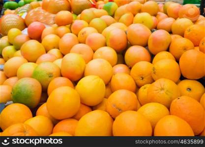 Pile of fresh oranges and mandarins at market