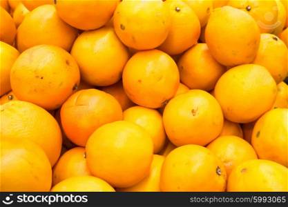 Pile of fresh oranges and mandarins at market