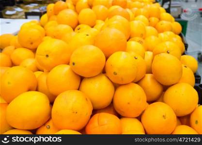 Pile of fresh oranges in a crate at market