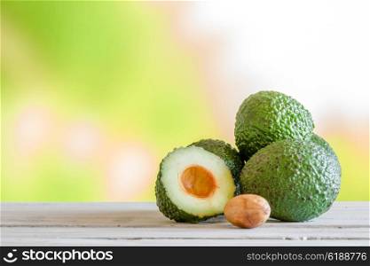 Pile of green avocado on a wooden table