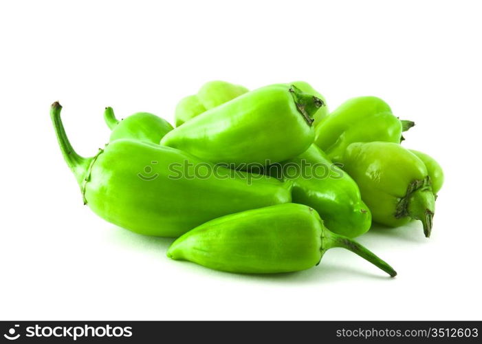 pile of green peppers isolated on a white background