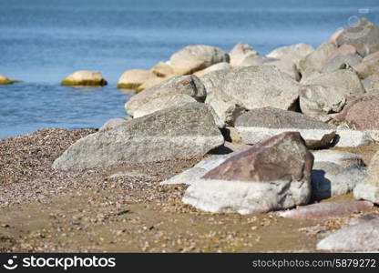 pile of large stones on sea beach