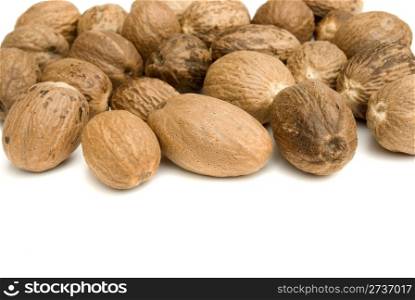 pile of nutmeg isolated on white background