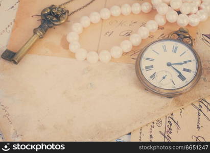 pile of old letters  and antique  clock vintage bckground with copy space, retro toned. mail  with  old clock