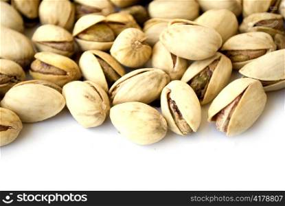 pile of pistachio nuts isolated on white background