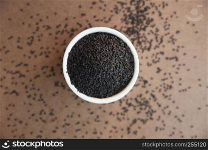 Pile of poppy seeds on wood background