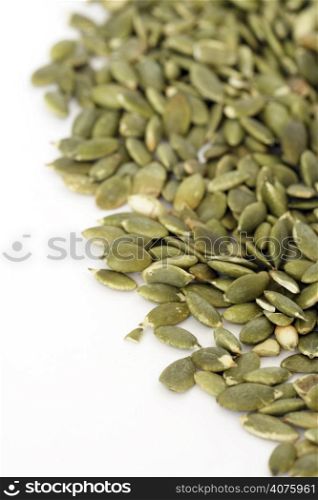 Pile of pumpkin seeds over white background