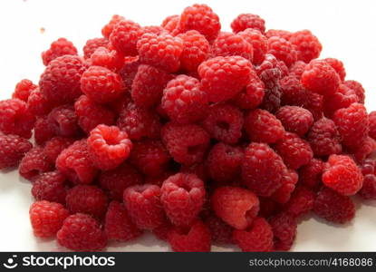 Pile of raspberries isolated on white background