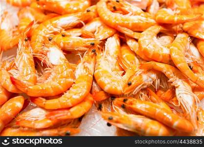Pile of red fresh shrimps at the market. Seafood texture for background