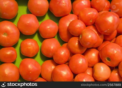 Pile of red tomatoes at produce market.