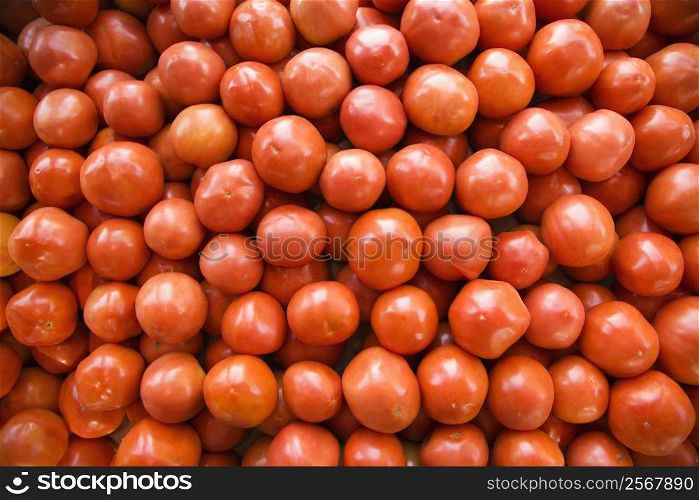 Pile of red tomatoes at produce market.