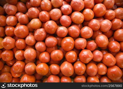 Pile of red tomatoes at produce market.