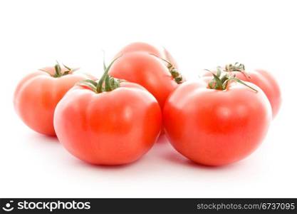 pile of red tomatoes isolated on white background